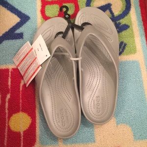 Crocs silver flip-flops.
